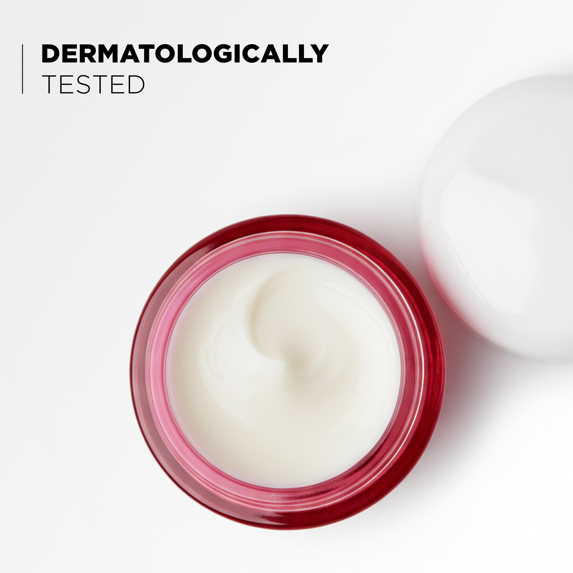 Open jar showing the cream texture, dermatologically tested