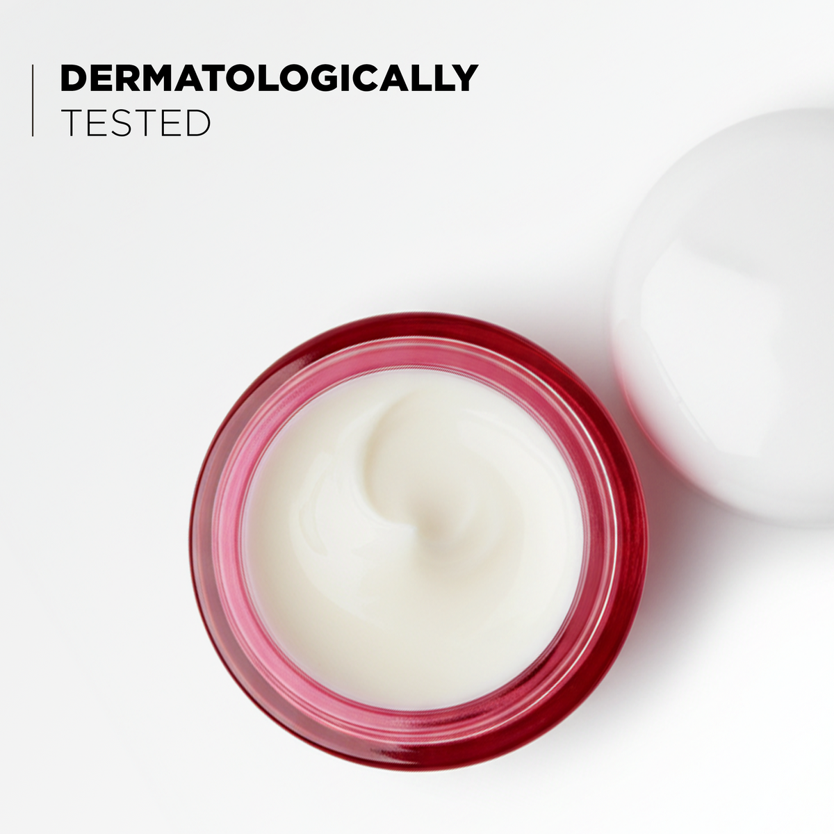 Open jar showing the cream texture, dermatologically tested